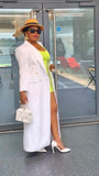 Woman in a stylish outfit with a white tailored longline coat