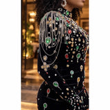 Close-up of multicoloured jewel embellishments and cascading shoulder chains on the St Zandas black mini dress