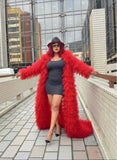 Person wearing a long red fluffy coat in an urban setting