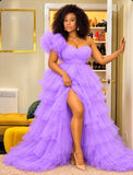 voluminous lavender purple tulle gown with a sweetheart neckline, one-quarter puff sleeve, side cutouts, and a high thigh slit