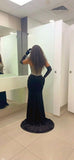 Back view of black velvet evening gown with beaded corset bodice and train luxury formal dress