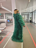 Back view of emerald tulle coat showing full-length train and cascading tiers
