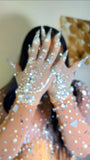 Person wearing sparkling silver gloves 