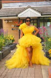 Yellow buttercream tulle high-low gown with layered skirt and dramatic train for special occasions