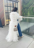 Back view of white ruffle tulle duster coat with cascading layers, dramatic statement fashion piece