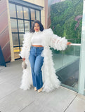 White ruffle tulle duster coat layered over jeans and crop top, statement luxury outfit for women